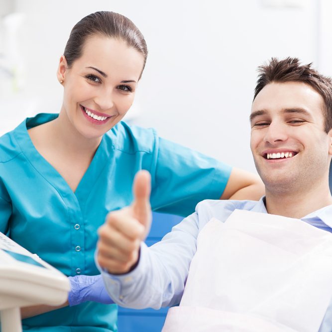 Man,Giving,Thumbs,Up,At,Dentist,Office